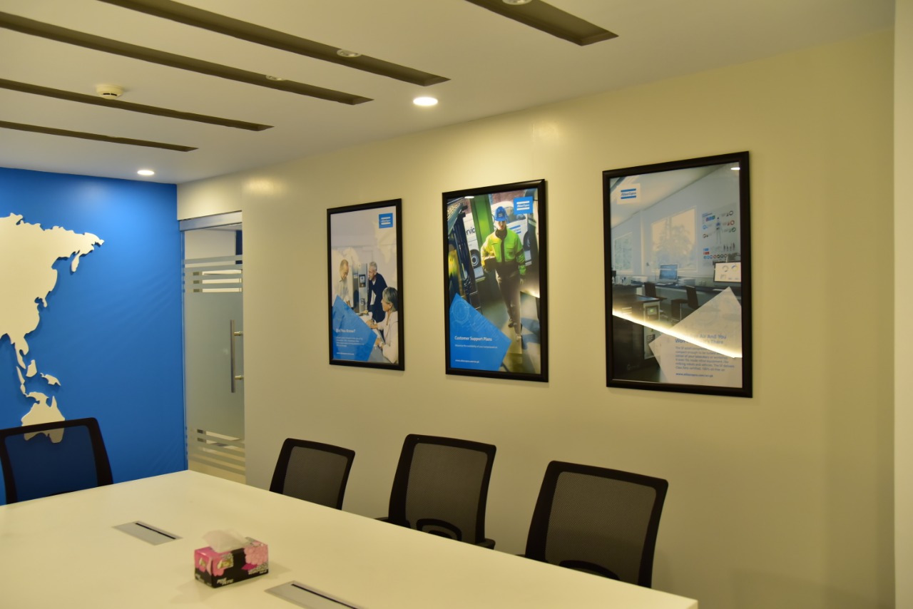 Boardroom wall with framed brand imagery