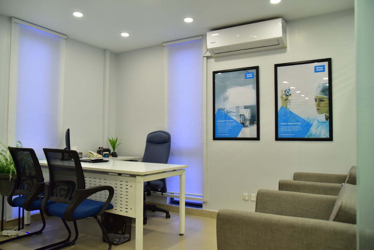 Consultation office with brand posters and roller blinds