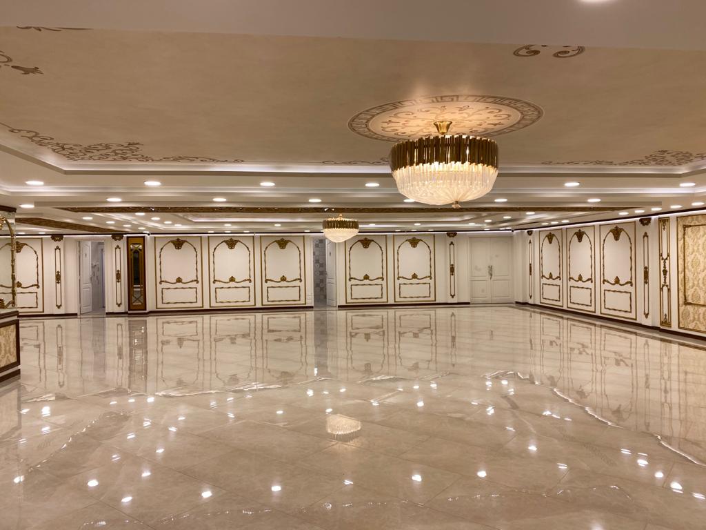 Classical white-and-gold ballroom with crystal drum chandeliers
