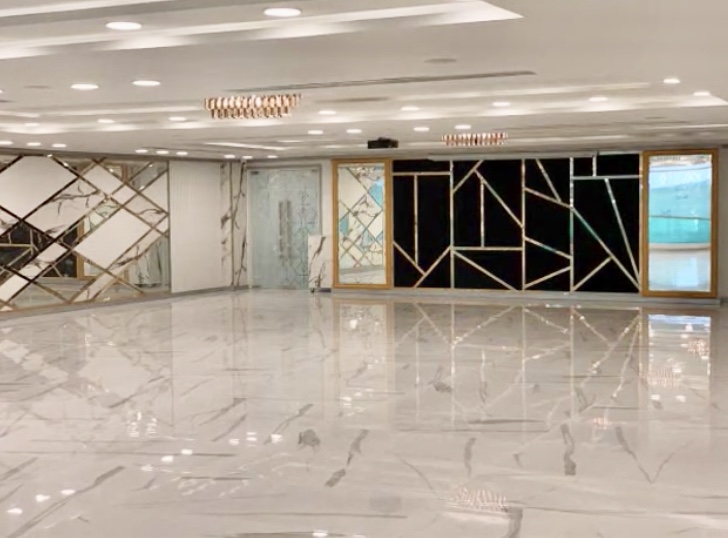 Contemporary hall with a marble and gold geometric mirror wall