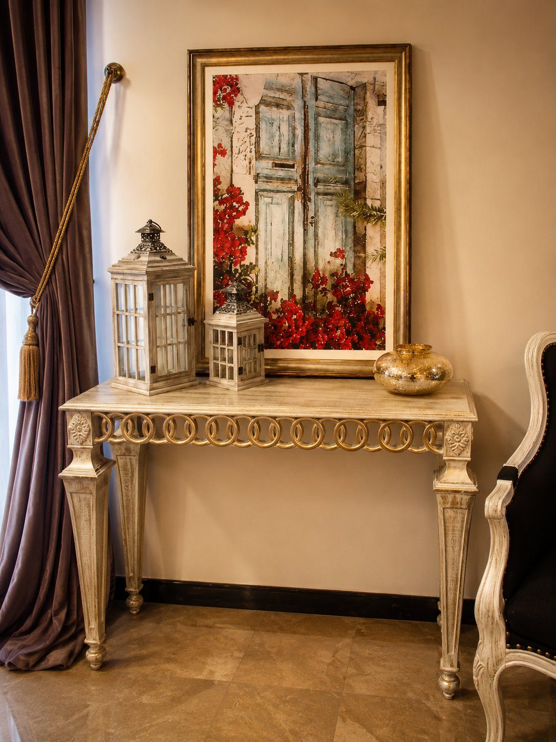 Console table with framed art print and twin lanterns