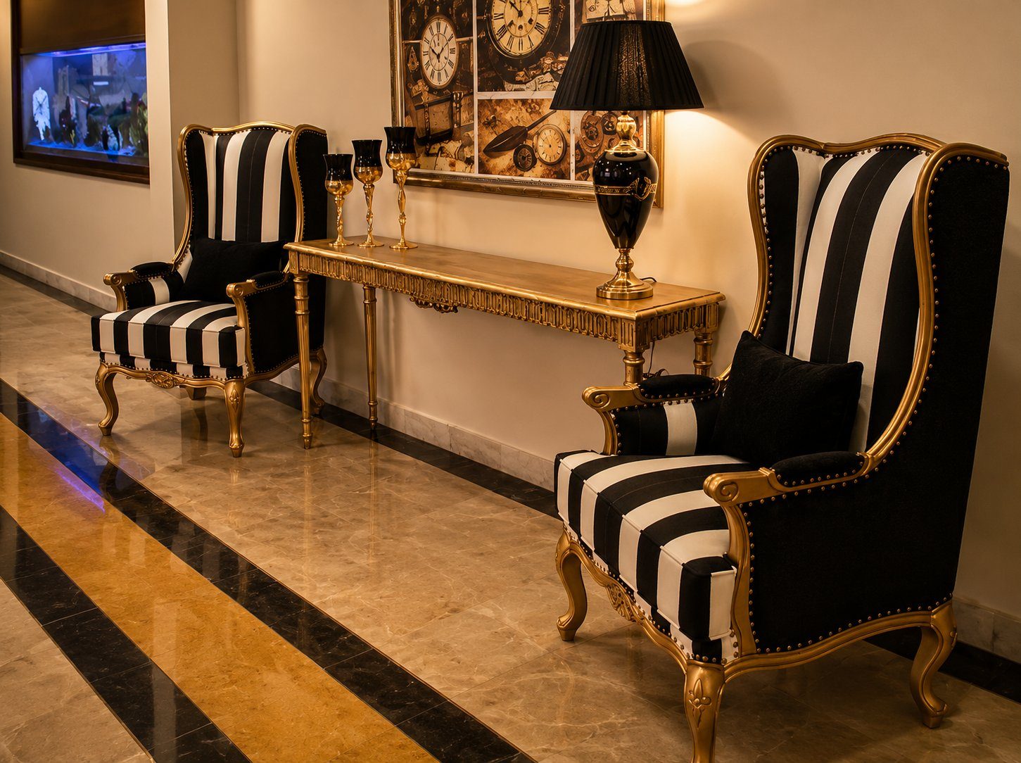 Black and white striped wingback chairs flanking gold console table