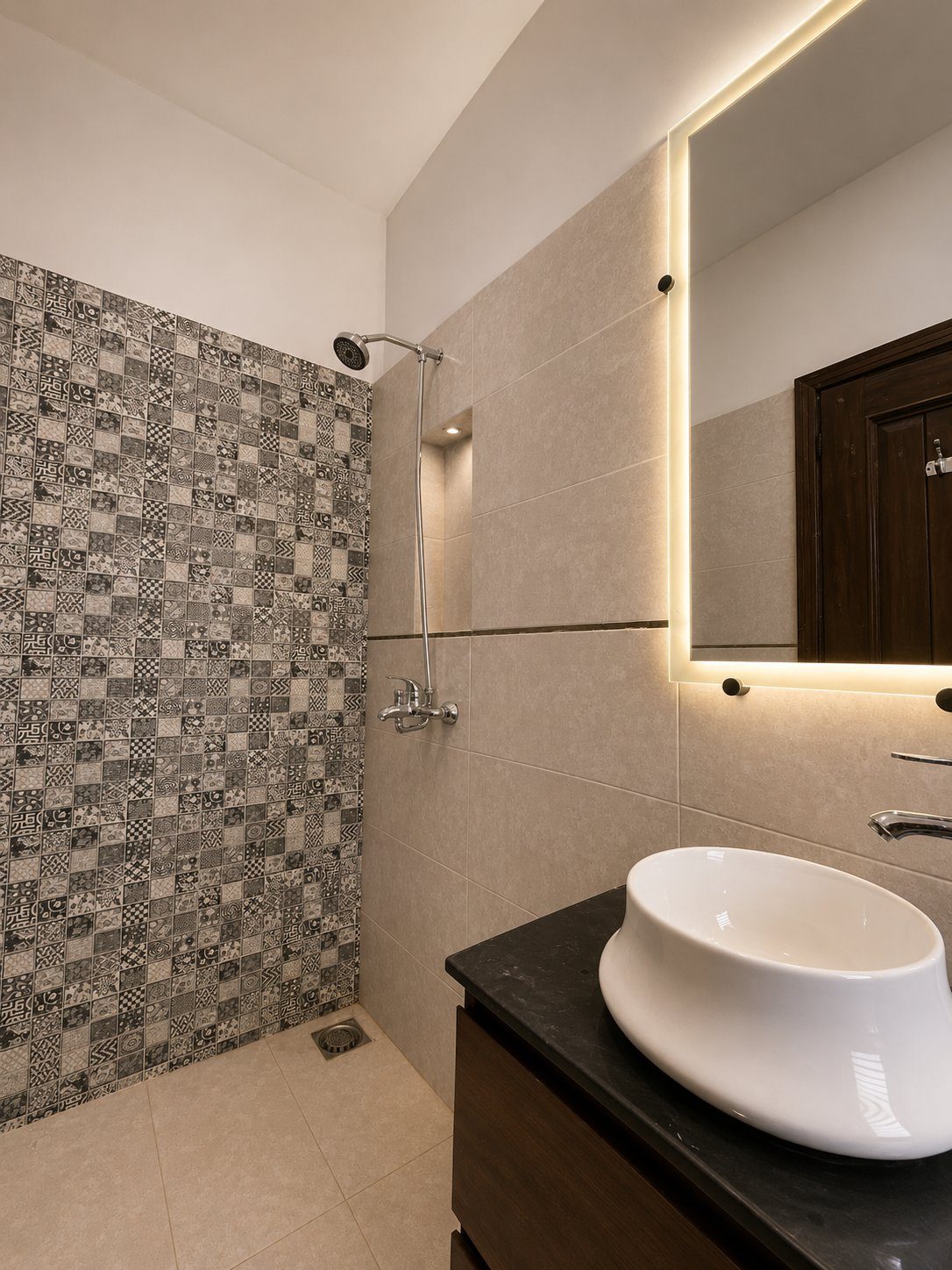 Patterned mosaic shower tile with backlit vanity mirror
