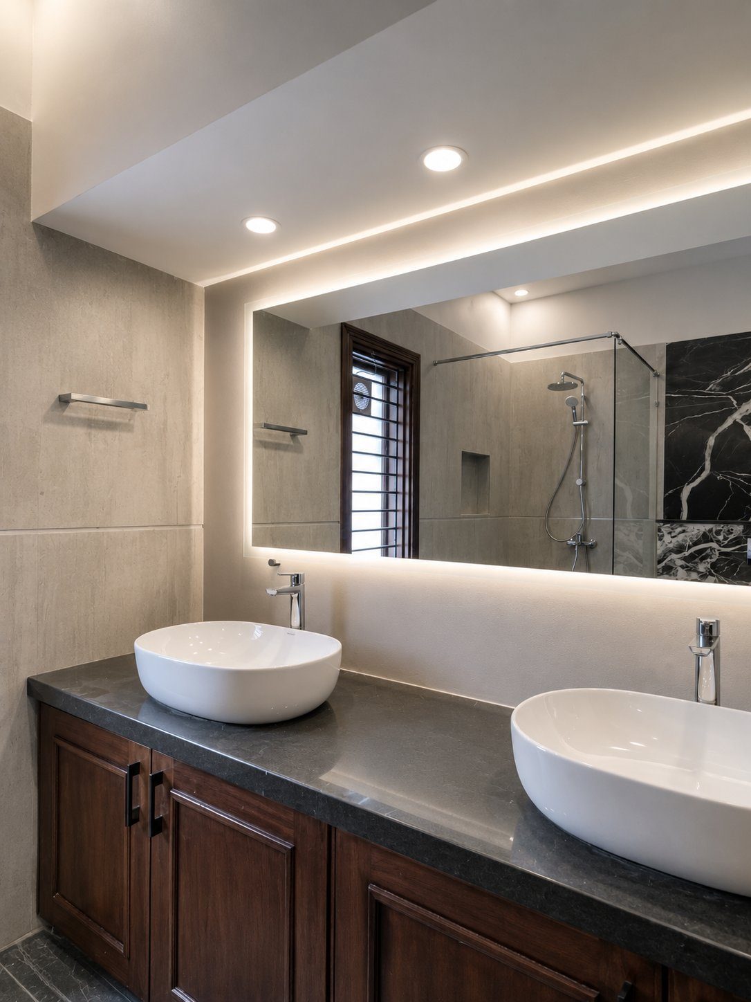 Double vanity with backlit mirror and dark wood cabinetry